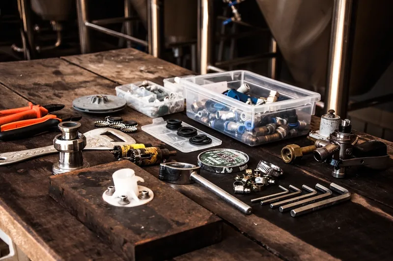 Plumbing tools and fittings laid out on a workbench